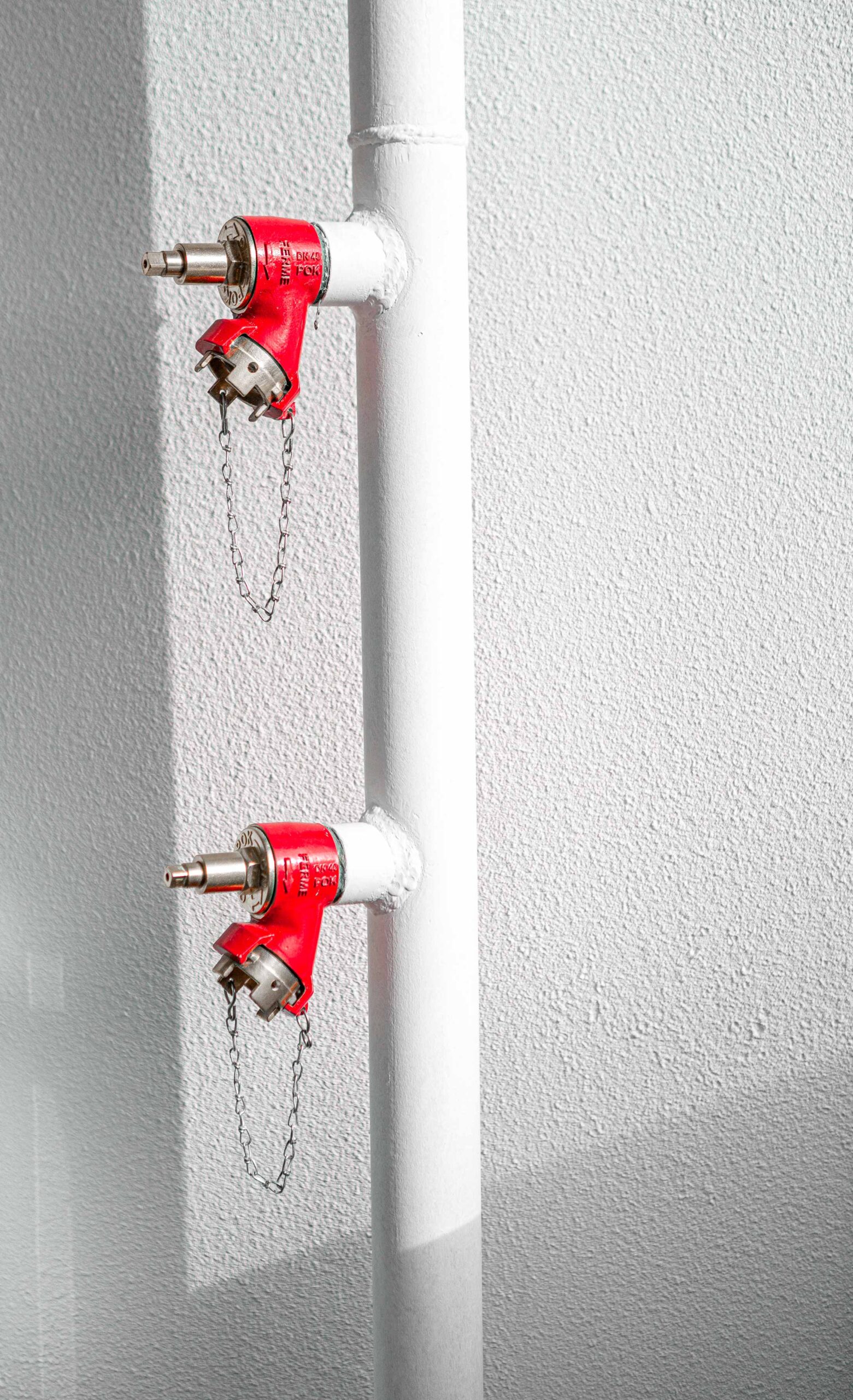 red-fire-extinguisher-white-wall